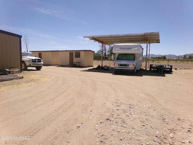 2474 W Victoria Ln, Willcox, AZ 85643 - view of car parking featuring a detached carport, a mountain view, and dirt driveway