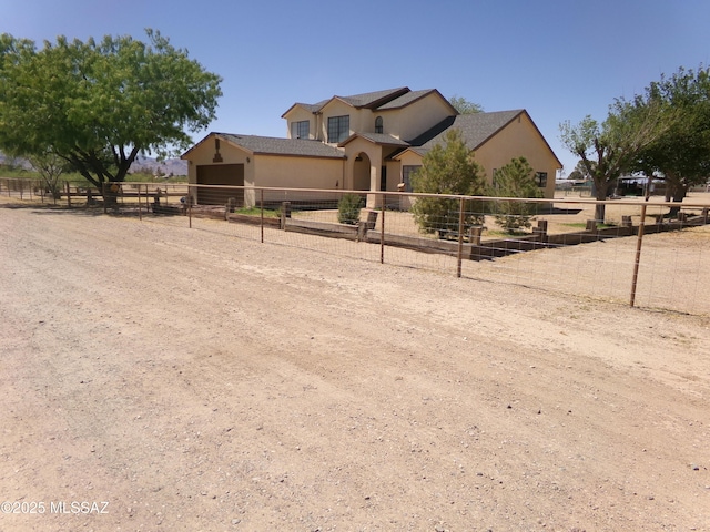 2474 W Victoria Ln, Willcox, AZ 85643 - view of front of home featuring volleyball court, stucco siding, and fence