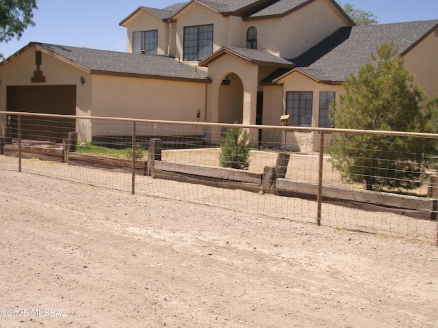 2474 W Victoria Ln, Willcox, AZ 85643 - view of front of home with stucco siding, fence, a garage, and a shingled roof
