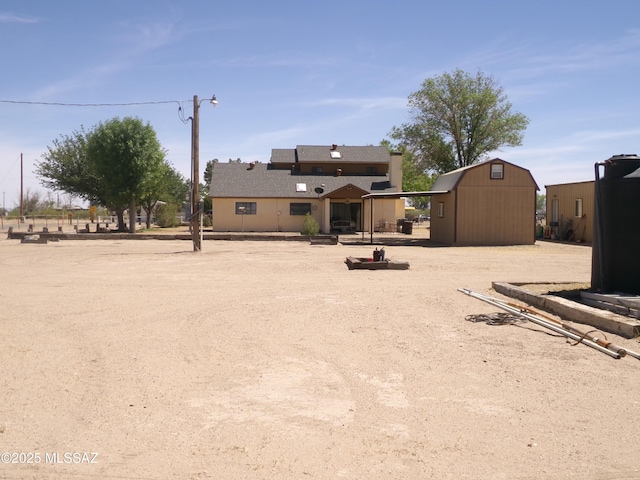 2474 W Victoria Ln, Willcox, AZ 85643 - rear view of property with an outdoor structure and a shed