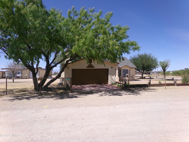 2474 W Victoria Ln, Willcox, AZ 85643 - view of front of property with a garage, stucco siding, and fence