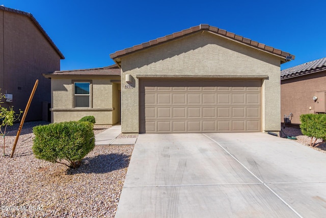 6210 S Open Desert Pl, Tucson, AZ 85706 - view of front of home featuring a garage, stucco siding, driveway, and a tile roof