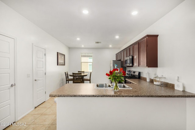 6210 S Open Desert Pl, Tucson, AZ 85706 - kitchen with appliances with stainless steel finishes, a peninsula, recessed lighting, light tile patterned flooring, and a sink