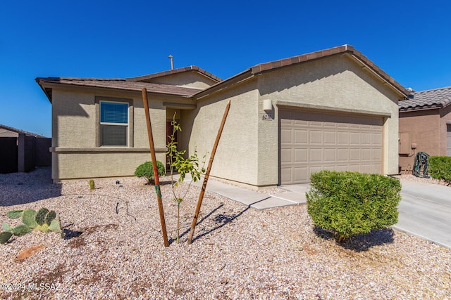 6210 S Open Desert Pl, Tucson, AZ 85706 - single story home with an attached garage, stucco siding, a tiled roof, and driveway