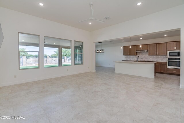 2559 E Wrightson View Dr, Green Valley, AZ 85614 - unfurnished living room with a ceiling fan, a sink, and recessed lighting