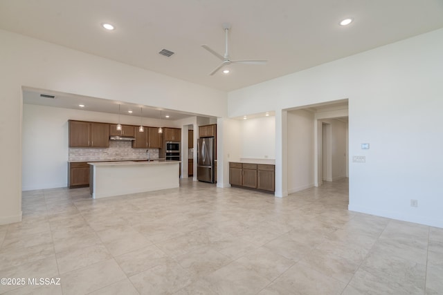 2559 E Wrightson View Dr, Green Valley, AZ 85614 - unfurnished living room featuring ceiling fan, recessed lighting, baseboards, and a sink