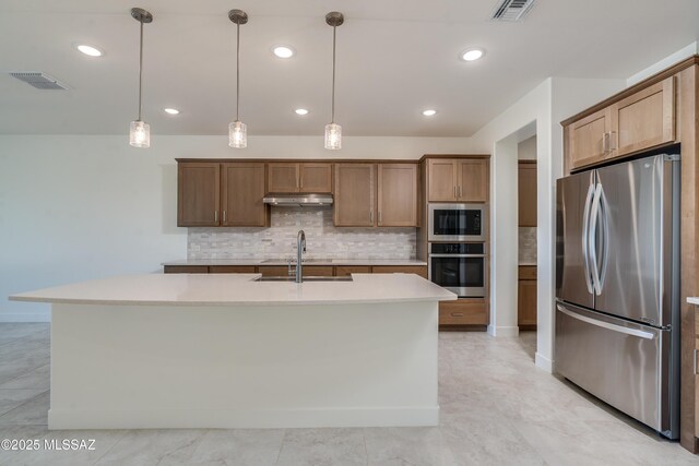 2559 E Wrightson View Dr, Green Valley, AZ 85614 - kitchen with stainless steel appliances, a sink, under cabinet range hood, tasteful backsplash, and light countertops