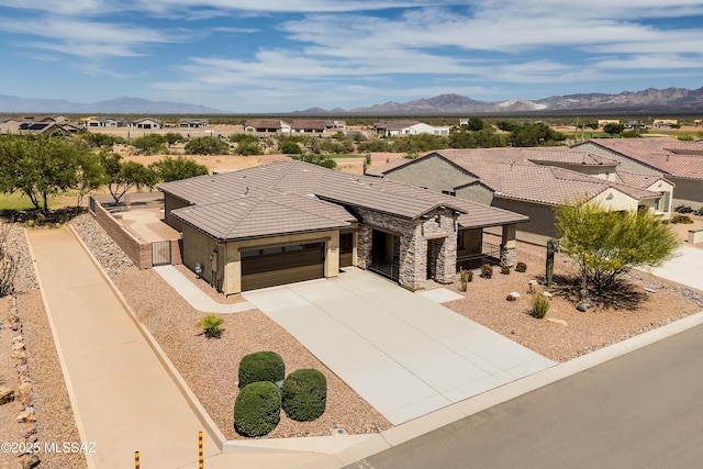 2559 E Wrightson View Dr, Green Valley, AZ 85614 - view of front facade featuring an attached garage, a mountain view, and concrete driveway