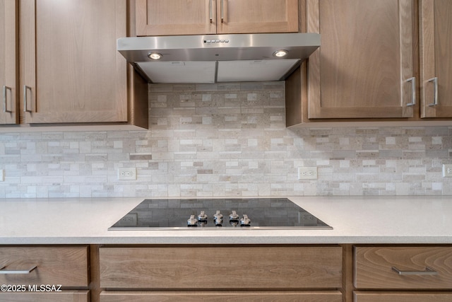 2559 E Wrightson View Dr, Green Valley, AZ 85614 - kitchen with ventilation hood, black electric stovetop, light countertops, and backsplash
