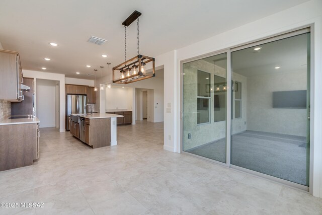 2559 E Wrightson View Dr, Green Valley, AZ 85614 - kitchen featuring light countertops, a center island with sink, decorative light fixtures, recessed lighting, and open floor plan