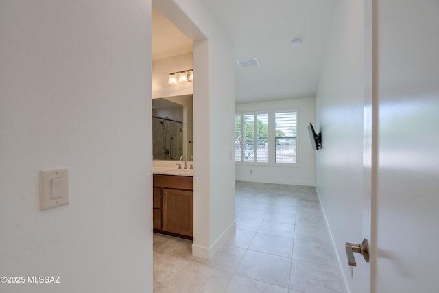 2559 E Wrightson View Dr, Green Valley, AZ 85614 - hall featuring a sink, light tile patterned floors, and baseboards