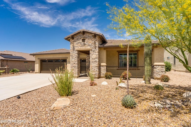 2559 E Wrightson View Dr, Green Valley, AZ 85614 - view of front facade with stucco siding, an attached garage, concrete driveway, stone siding, and a porch