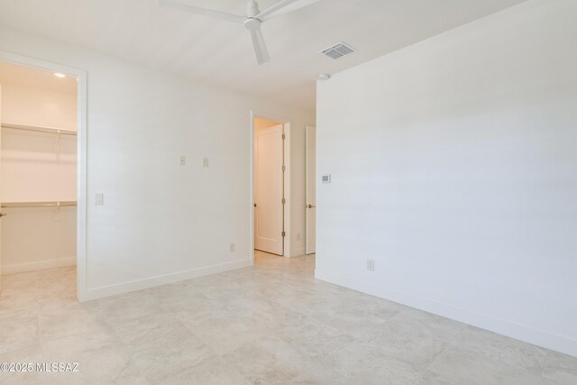 2559 E Wrightson View Dr, Green Valley, AZ 85614 - unfurnished bedroom with a spacious closet, baseboards, a closet, and ceiling fan
