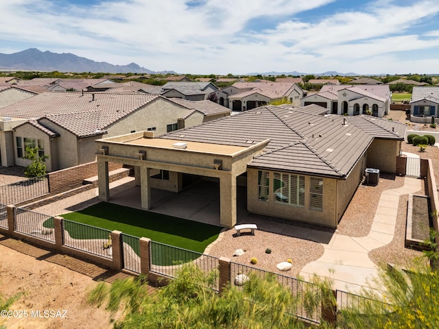 2559 E Wrightson View Dr, Green Valley, AZ 85614 - back of house featuring a fenced front yard, a residential view, and a patio
