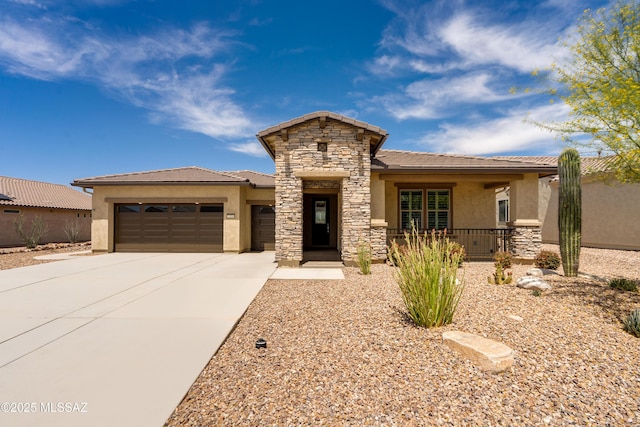 2559 E Wrightson View Dr, Green Valley, AZ 85614 - view of front facade with stucco siding, a garage, a tiled roof, driveway, and stone siding