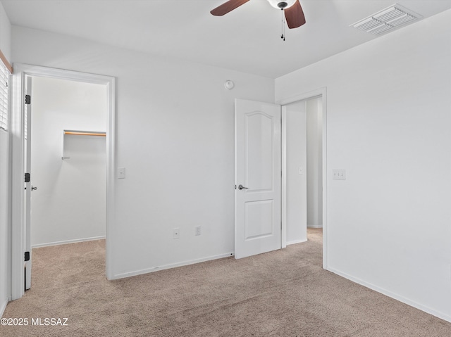 4801 E Canary Grass Dr, Tucson, AZ 85756 - unfurnished bedroom featuring carpet flooring, a spacious closet, a closet, baseboards, and ceiling fan