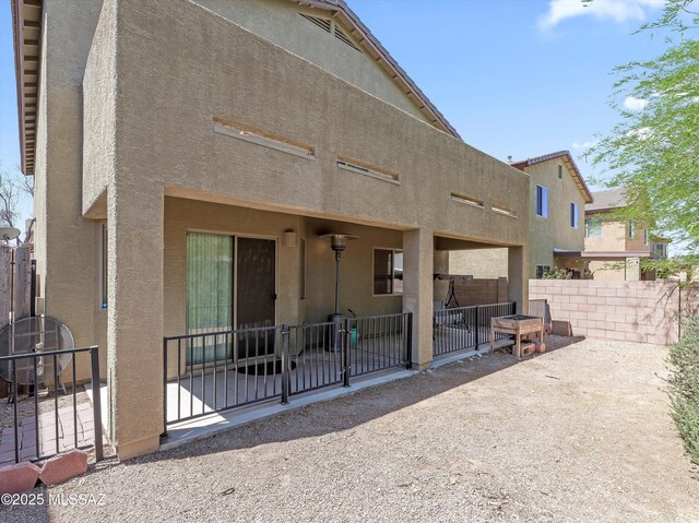 4801 E Canary Grass Dr, Tucson, AZ 85756 - back of house with a patio, stucco siding, fence, and a gate