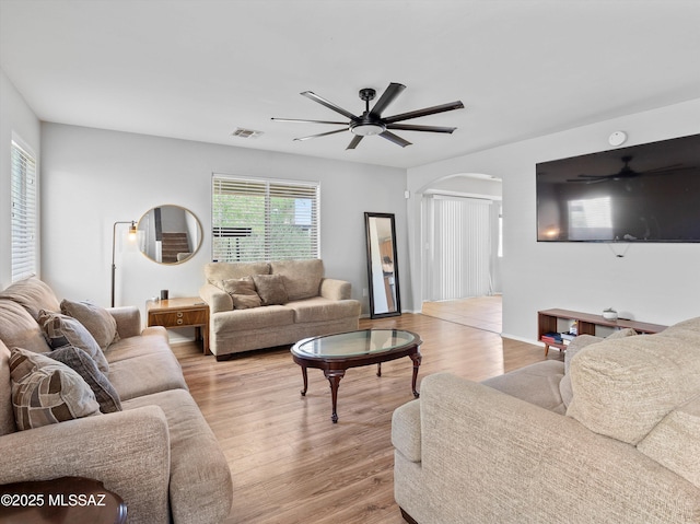 4801 E Canary Grass Dr, Tucson, AZ 85756 - living area featuring arched walkways, ceiling fan, and light wood-style floors