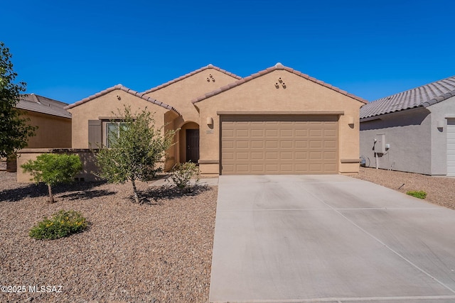 12622 N Wildrose Dr, Marana, AZ 85653 - mediterranean / spanish house featuring a garage, concrete driveway, stucco siding, and a tiled roof