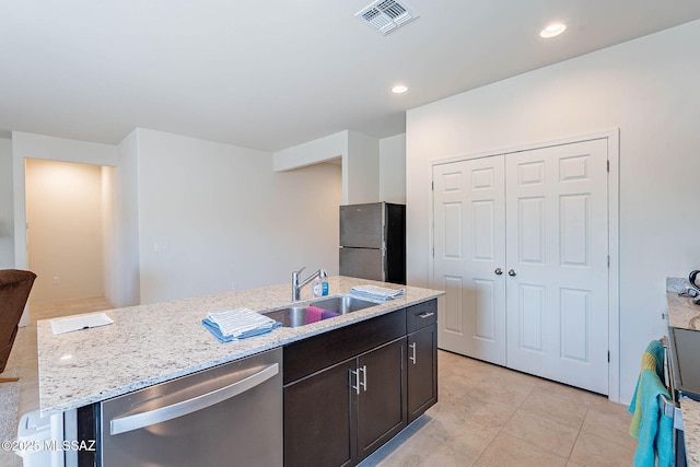 12622 N Wildrose Dr, Marana, AZ 85653 - kitchen with stainless steel appliances, a sink, a center island with sink, light stone countertops, and recessed lighting