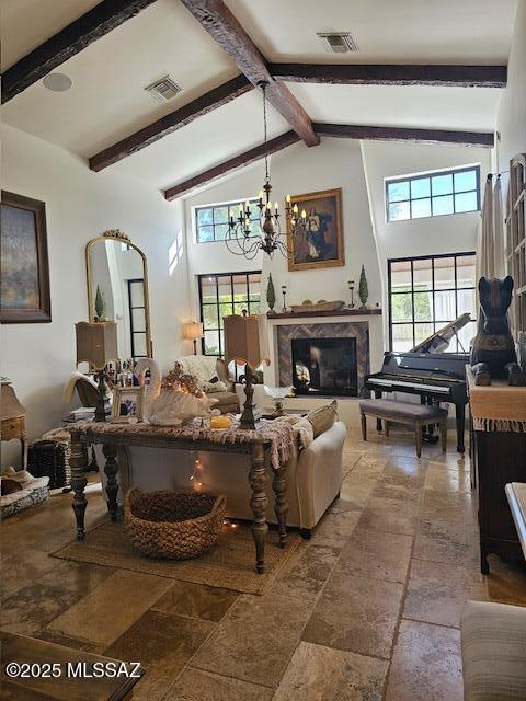 7774 E Cleary Way, Tucson, AZ 85715 - living area with high vaulted ceiling, plenty of natural light, beam ceiling, a chandelier, and a fireplace