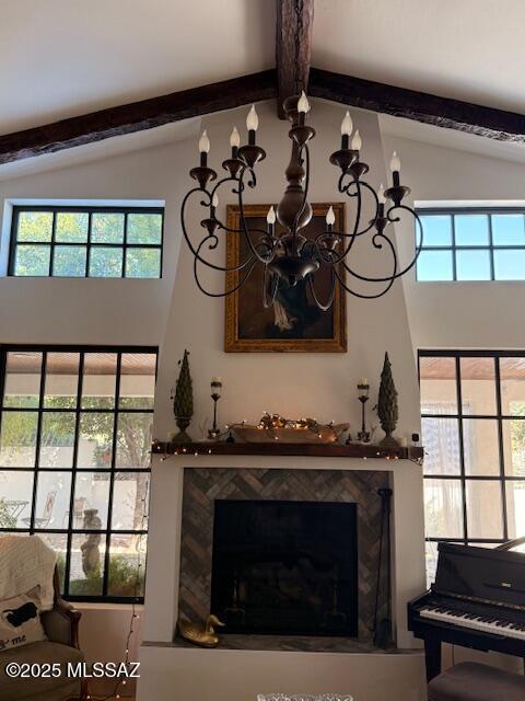 7774 E Cleary Way, Tucson, AZ 85715 - detailed view of a chandelier, beamed ceiling, and a premium fireplace