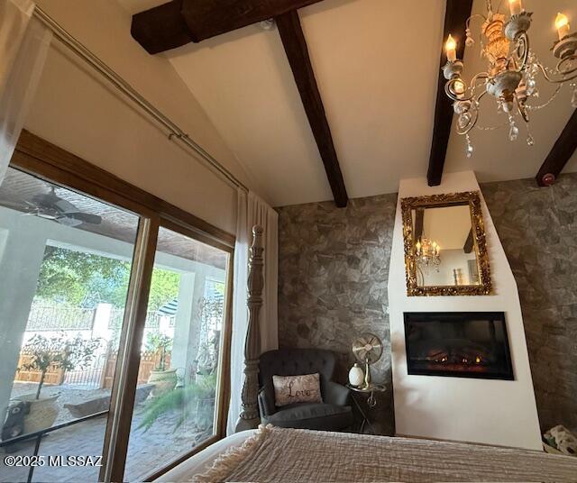 7774 E Cleary Way, Tucson, AZ 85715 - bedroom featuring beam ceiling, a glass covered fireplace, and a chandelier