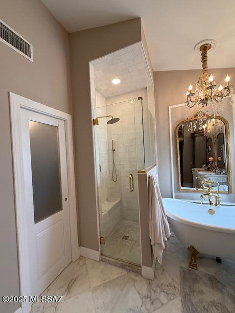 7774 E Cleary Way, Tucson, AZ 85715 - bathroom featuring a soaking tub, marble finish flooring, a shower stall, a chandelier, and baseboards