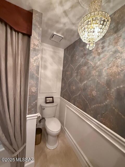 7774 E Cleary Way, Tucson, AZ 85715 - bathroom featuring toilet, wainscoting, a chandelier, a decorative wall, and tile patterned flooring
