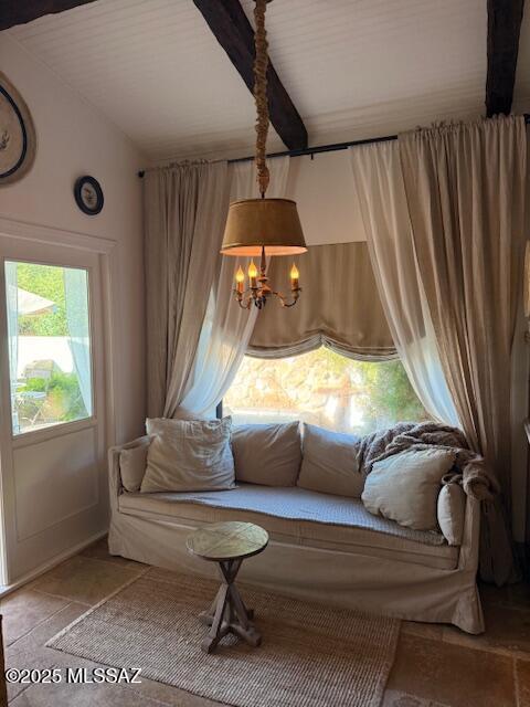 7774 E Cleary Way, Tucson, AZ 85715 - living area featuring a chandelier, stone tile floors, and beam ceiling