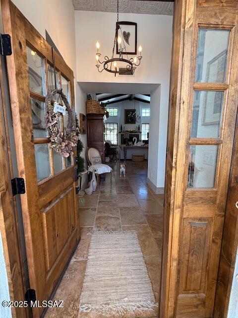 7774 E Cleary Way, Tucson, AZ 85715 - entrance foyer featuring a chandelier, stone tile flooring, and baseboards