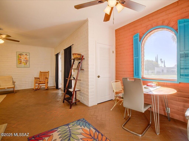 641 W Las Lomitas Rd, Tucson, AZ 85704 - dining area with ceiling fan, brick wall, and brick patterned floors