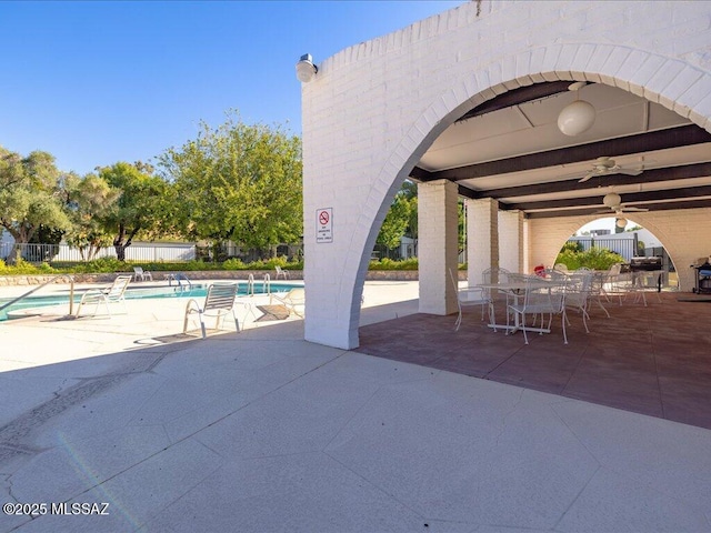 641 W Las Lomitas Rd, Tucson, AZ 85704 - view of patio featuring a community pool, ceiling fan, fence, and outdoor dining area