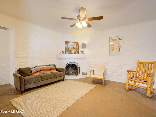 641 W Las Lomitas Rd, Tucson, AZ 85704 - living area featuring brick wall, ceiling fan, a brick fireplace, crown molding, and brick flooring