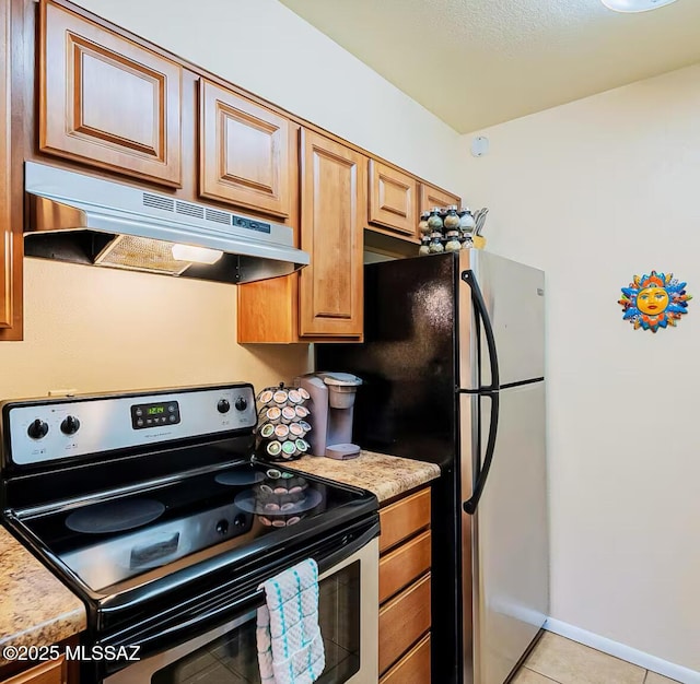1745 E Glenn St Unit 133, Tucson, AZ 85719 - kitchen with stainless steel appliances, under cabinet range hood, light countertops, and light tile patterned floors
