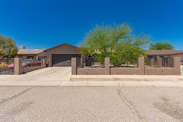 view of front facade with a fenced front yard, stucco siding, an attached garage, and driveway