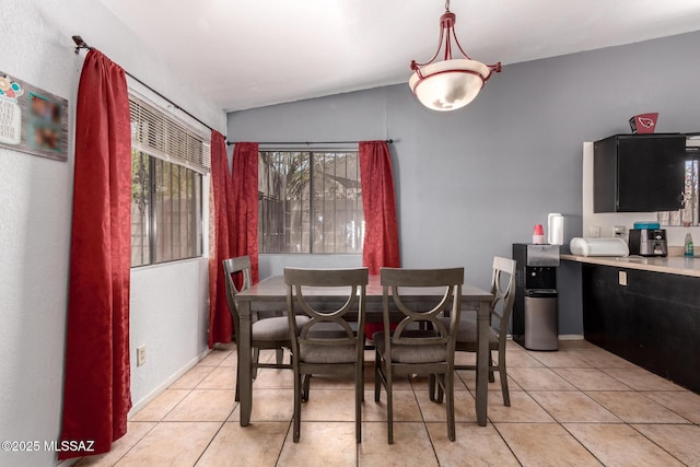 dining room with vaulted ceiling and light tile patterned flooring