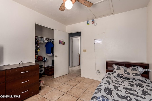 bedroom with light tile patterned flooring, a closet, and a ceiling fan