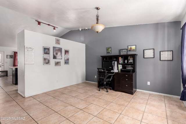 office featuring track lighting, light tile patterned floors, vaulted ceiling, and baseboards