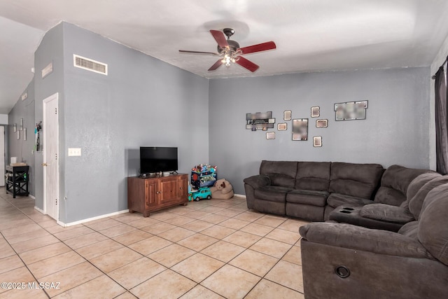 living area featuring light tile patterned floors, ceiling fan, and baseboards