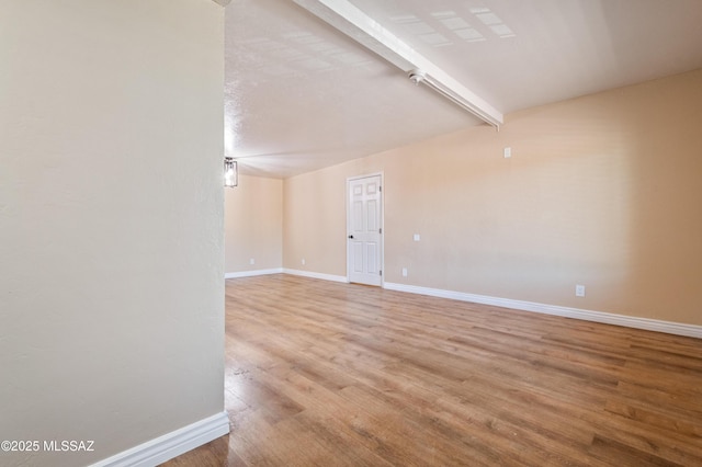 2002 E Pinon Dr, Tucson, AZ 85706 - spare room with wood finished floors, baseboards, and beam ceiling