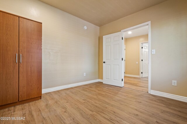 2002 E Pinon Dr, Tucson, AZ 85706 - unfurnished bedroom with light wood-type flooring and baseboards