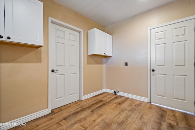 2002 E Pinon Dr, Tucson, AZ 85706 - laundry room featuring electric dryer hookup, light wood-style flooring, cabinet space, and baseboards