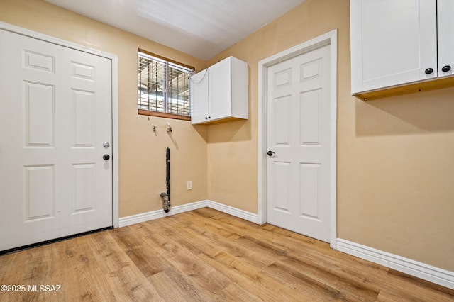 2002 E Pinon Dr, Tucson, AZ 85706 - laundry room with cabinet space, light wood finished floors, baseboards, and hookup for a washing machine