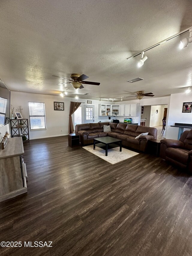 1609 S 12th Ave, Safford, AZ 85546 - living area featuring ceiling fan, a textured ceiling, plenty of natural light, and dark wood-style floors