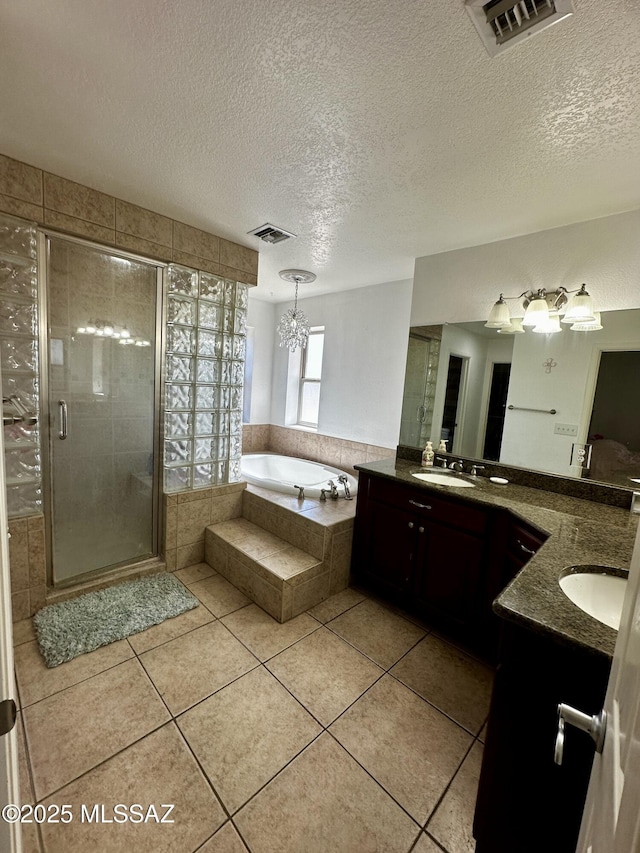 1609 S 12th Ave, Safford, AZ 85546 - full bathroom featuring a bath, a stall shower, double vanity, tile patterned floors, and a textured ceiling