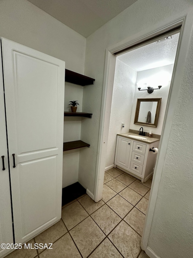 1609 S 12th Ave, Safford, AZ 85546 - bathroom with tile patterned floors, vanity, and baseboards