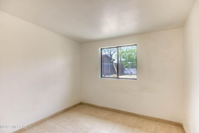 4842 E 27th St, Tucson, AZ 85711 - empty room featuring baseboards and light tile patterned floors