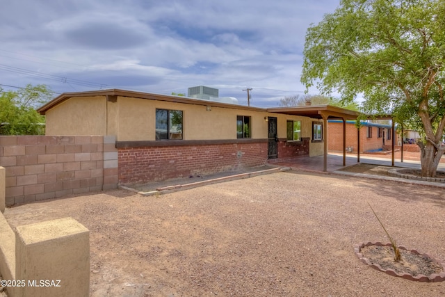 4842 E 27th St, Tucson, AZ 85711 - single story home with a patio area, fence, stucco siding, and brick siding