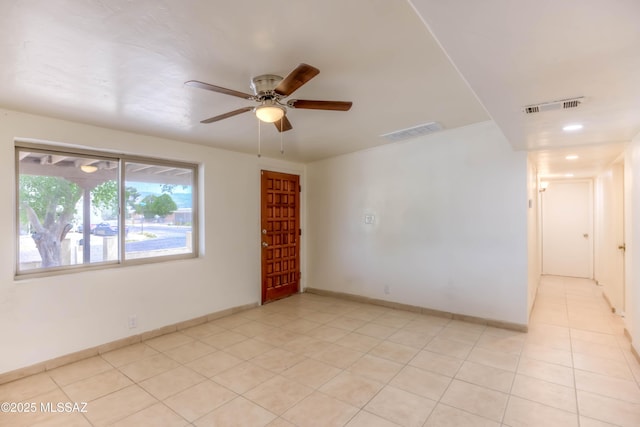4842 E 27th St, Tucson, AZ 85711 - spare room featuring ceiling fan, light tile patterned floors, and baseboards